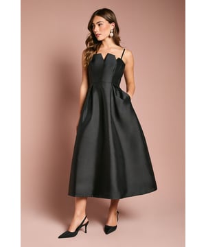 Elegant notch neck detail creates a sophisticated neckline with delicate spaghetti straps
        Structured twill fabric provides a beautiful silhouette that maintains its shape throughout wear
        Flattering midi length falls gracefully below the knee for a refined look
        Practical side pockets add functionality without compromising on style
        Full skirt design with pleating detail creates dramatic volume and movement
    
    This striking Coast midi dress showcases timeless elegance with its distinctive notch neck detail and clean architectural lines. The structured twill fabric creates a magnificent silhouette that holds its shape beautifully, whilst the full skirt with subtle pleating offers graceful movement as you walk. Perfect for weddings, race days or formal garden parties, this dress makes a sophisticated statement. Style with classic court heels and statement earrings as shown for an effortlessly chic ensemble. For cooler evenings, layer with a tailored blazer or delicate wrap. The versatile design transitions seamlessly from daytime celebrations to evening receptions, making it a wardrobe essential for your most memorable occasions. The practical side pockets add a thoughtful touch to this otherwise formal piece.