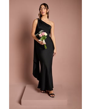 Striking one-shoulder design with elegant gold trim detail
        Luxurious satin fabric creates a smooth, flowing silhouette
        Dramatic draped shoulder panel adds movement and sophistication
        Figure-flattering maxi length with subtle fishtail hem
        Sleek, streamlined cut perfect for formal bridal party coordination
    
    This captivating bridesmaids dress from Coast combines timeless elegance with contemporary design. The asymmetric one-shoulder neckline creates a graceful focal point, whilst the flowing draped panel adds a touch of drama as you move. The satin fabric catches the light beautifully, complemented by the refined gold trim that adds a subtle touch of opulence. The fitted bodice gently flares to a floor-sweeping maxi length, creating a silhouette that flatters every figure. Style with delicate gold jewellery and a simple updo to showcase the distinctive neckline. Complete your bridal party look with strappy heels and a small bouquet that complements the bride's floral arrangements. This sophisticated dress ensures you'll stand confidently beside the bride on her special day, looking effortlessly polished in wedding photographs that will be treasured for years to come.