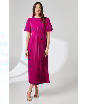 Elegant midi dress featuring a sophisticated pleated skirt for graceful movement
        Charming puff sleeves add a contemporary touch to this classic silhouette
        Neat crew neckline provides a refined finish suitable for formal occasions
        Practical side pockets discreetly integrated into the pleated design
        Flattering cinched waist creates a feminine, defined silhouette
    
    This striking Principles midi dress combines timeless elegance with modern detailing. The pleated skirt creates beautiful movement as you walk, whilst the puff sleeves add a touch of drama to the sophisticated silhouette. Perfect for special occasions, this dress makes a statement at weddings, garden parties or race days when paired with strappy heeled sandals and delicate jewellery as shown. For cooler evenings, layer with a tailored blazer or a lightweight pashmina. The versatile crew neckline works beautifully with both statement necklaces or simple pendants, allowing you to customise your look. The practical side pockets add functionality without compromising on style, making this a truly versatile addition to your occasion wardrobe.