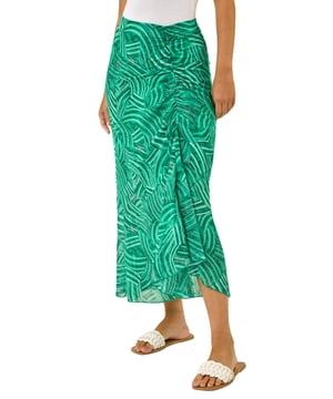 Marked Ruffle Midi Skirt from Roman. Make a stylish statement this Spring/Summer with this marked ruffle skirt. This midi length skirt is designed with a unique ruffle detail that adds a playful touch to your outfit. The side zip fastening ensures a sleek, flattering fit while making it easy to slip on and off. Pair it with a chic cami top and trendy sandals for a fabulous look that's perfect for any sunny day outing!