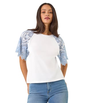 Dusk Broderie Contrast Sleeve Top from Roman. Give your casual wardrobe a stylish update with this contrast sleeve top. Featuring a timeless round neckline and short raglan sleeves with a stunning broderie contrast design. Crafted from a soft, breathable cotton fabric perfect for the Spring Summer season, this top finishes in a flattering tee shape. Pair with a denim jacket and jeggings for a complete look!