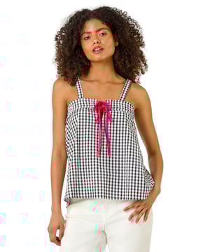 Mono Gingham Cami Top from Roman. This chic cami top features an all over mono gingham print, adding a fresh and timeless pattern to your wardrobe. With a flattering hip-length finish, it’s perfect for layering or wearing on its own. Its lightweight fabric makes it ideal for warmer days, and its versatile design pairs beautifully with jeans, skirts, or shorts for a casual yet stylish look.