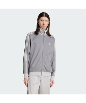 Sometimes history just gets it right. Taken straight from the adidas archives, this signature track top nails a timeless look. An embroidered Trefoil logo adds a touch of pizzazz, and the supremely soft cotton blend makes it perfect for everyday wear. With a slim fit and full zip, it gives any outfit a dash of attitude. Our favourite part: the stand-up collar for that tailored vibe. A minimum of 70% of this product is a blend of recycled and renewable materials.  - Slim fit - Full zip with ribbed stand up collar - 52% cotton, 48% polyester (recycled) - Zip pockets - Ribbed hem and cuffs  Shipped by adidas