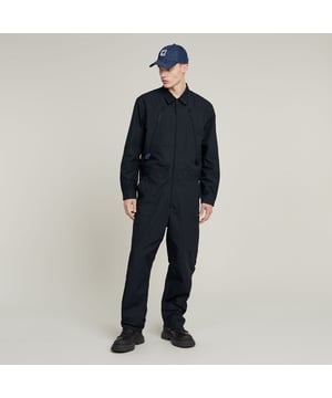 Shirt collar. Zipper closure. Cuffs, button closure. Zip pockets at the chest, inset pockets, single back pocket with button. Adjustable waist strap, snap buttons. Zip closure. Mid waist. Jumpsuit Flight offers deep zip pockets at the front. By adjusting the snap buttons on the waist tape, a tighter waistline can be created. 100% Cotton. Rigid