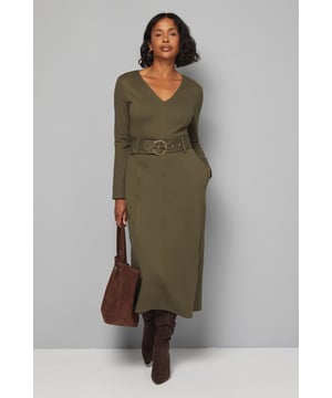 Flattering V-neckline that frames the dcolletage beautifully
        Striking circular buckle belt that cinches the waist for a defined silhouette
        Practical side pockets for everyday essentials
        Versatile midi length perfect for day-to-night styling
        Comfortable ponte jersey fabric with gentle stretch for all-day wear
    
    This sophisticated Wallis midi dress combines effortless style with practical comfort. The flattering V-neckline and waist-defining belt with its distinctive circular buckle create a feminine silhouette that works wonderfully for various daytime occasions. Style with knee-high boots as shown for a polished autumn look, or pair with ballet flats and a denim jacket for casual weekend brunches. The practical side pockets add functionality without compromising on style, while the stretchy ponte jersey fabric ensures you stay comfortable throughout the day. Perfect for family gatherings, lunch dates or office wear, this dress can be accessorised with a statement necklace and crossbody bag for shopping trips, or dressed down with trainers and an oversized cardigan for coffee mornings. A versatile wardrobe staple that combines Wallis's signature sophistication with everyday wearability.