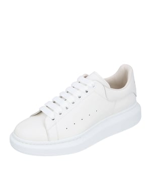 - White lace-up sneakers made from smooth calfskin with a round toe
- Flat, wide laces and McQueen logo on the tongue and heel cap
- Extra-large rubber sole
- Made in Italy