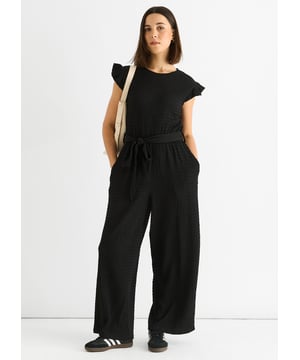 Unser schwarzer Stretch-Jumpsuit mit Rüschen und elastischem Bund ist mühelos stilvoll und bequem und die perfekte Ergänzung für Ihre Garderobe. Der elastische Bund und die Rüschen verleihen ihm einen Hauch von lässigem Charme, während der schwarze Stretchstoff für Komfort und Bewegungsfreiheit sorgt. Setzen Sie ein Statement, ohne auf Komfort zu verzichten.