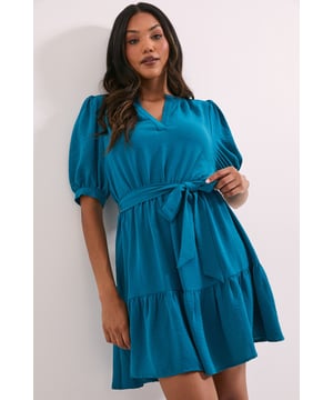 Flattering V-neckline with elegant puff sleeves for a feminine silhouette
        Belted waist design that accentuates your figure while providing adjustable comfort
        Tiered ruffle hem adding playful movement and dimension to this mini dress
        Versatile overhead style with a relaxed fit through the body
        Soft woven fabric that drapes beautifully for all-day comfort
    
    This charming Dorothy Perkins mini dress combines contemporary style with effortless wearability. The puff sleeves create a delightful vintage-inspired look, while the belted waist offers a customisable fit that flatters your natural shape. Perfect for casual gatherings, the tiered hem adds a touch of playfulness to your ensemble. Style with knee-high boots for a trendy daytime look, or pair with ballet flats and a denim jacket for weekend brunches with friends. The V-neckline provides a modest yet stylish detail that works beautifully with delicate jewellery. This versatile piece transitions seamlessly from family gatherings to baby showers, offering the ideal balance of comfort and style. The easy-to-wear silhouette makes it a wardrobe essential that you'll reach for time and again throughout the seasons.