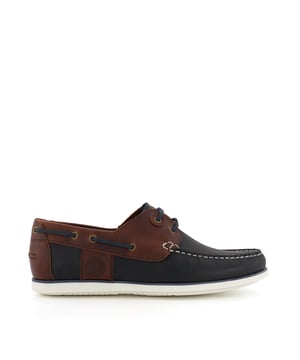 The Men's Barbour Wake is a classic style boat shoe, with contrast thread detailing, two eyelets and quintessential lace detailing. Crafted from the finest material and promising endless comfort, this timeless silhouette is finished with subtle Barbour branding that enhances the style. Set on a contrasting sole, they pair perfectly with rolled-up chinos and chambray shirts.