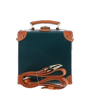 The Ashwood Leather Trinket Box is a limited-edition statement accessory inspired by the golden age of travel, designed to add a romantic flair to your collection. Handcrafted from premium full-grain leather, its structured design features leather-trimmed corners reminiscent of vintage trunk suitcases. The compact, lined interior provides space for a smartphone and a few small essentials, making it both stylish and practical. With a petite top handle and a detachable, adjustable cross-body leather strap, this versatile piece can be carried by hand or worn for hands-free convenience. Dimensions: 18.5cm (L) x 18.5cm (H) x 10cm (W).