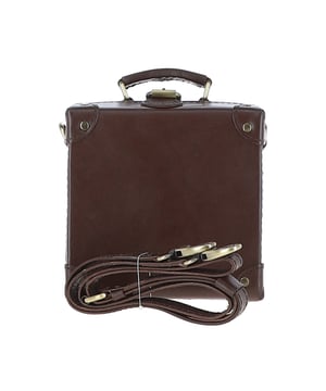 The Ashwood Leather Trinket Box is a limited-edition statement accessory inspired by the golden age of travel, designed to add a romantic flair to your collection. Handcrafted from premium full-grain leather, its structured design features leather-trimmed corners reminiscent of vintage trunk suitcases. The compact, lined interior provides space for a smartphone and a few small essentials, making it both stylish and practical. With a petite top handle and a detachable, adjustable cross-body leather strap, this versatile piece can be carried by hand or worn for hands-free convenience. Dimensions: 18.5cm (L) x 18.5cm (H) x 10cm (W).