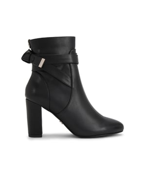 This Carvela Tempt ankle boot features a black leather alternative upper. There is a bow detail at the back of the ankle with gold tone branding. The inner side of the ankle features a zip for comfort. Heel height: 90mm.