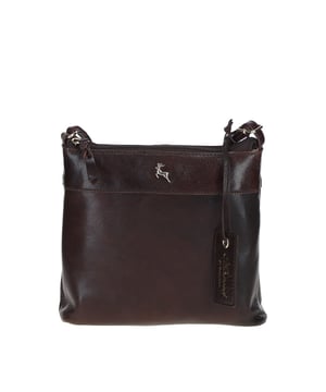 Discover the Ashwood Leather Crossbody Bag, a perfect blend of style and practicality crafted from genuine Ashwood leather. Featuring a main top zip closure, elegant golden hardware, and fully lined interior, this versatile bag offers ample organization with one slip pocket and one zip pocket inside, plus an additional zip pocket on the back. The bag is adorned with an Ashwood leather charm, enhancing its sophisticated look. With dimensions of 21 cm (L) x 6 cm (W) x 20 cm (H) and an adjustable dropdown length ranging from 37 cm to 75 cm, this crossbody bag is ideal for both casual and formal occasions, seamlessly combining timeless design and everyday functionality.