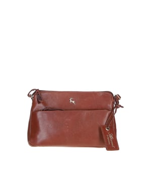 This elegant leather crossbody bag combines functionality and style, perfect for daily use. Made from premium leather with gold-coloured hardware, it offers a spacious main compartment, two internal pockets for organised storage, and an outer zip compartment for easy access to essentials. The adjustable shoulder strap provides versatile carrying options, ensuring comfort and practicality. Dimensions: (L) 23.5 cm x (W) 5.5 cm x (H) 15 cm.