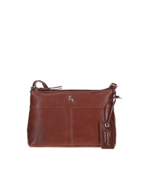 This stylish leather crossbody bag combines elegance and functionality, perfect for daily use. Crafted from premium leather with gold-coloured hardware, it features a spacious main compartment and two internal pockets for organised storage. The adjustable shoulder strap ensures a comfortable fit, while its sleek design adds a touch of sophistication to any outfit. Dimensions: (L) 24 cm x (W) 6 cm x (H) 15 cm.