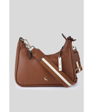 The "Bella Toscana" Real Leather Crossbody Bag by Ashwood Leather is a fine representation of craftsmanship and style. This sophisticated accessory showcases a rich orange hue that is bound to make a statement wherever you go. The bag is adorned with metallic gold hardware that not only adds a touch of luxury but also ensures durability. This bag seamlessly blends functionality with fashion. Its compact size makes it perfect for everyday use, while the intricate details elevate it to a piece of luxury. Whether you're headed to a casual outing or a formal event, the "Bella Toscana" is sure to be your perfect companion. Dimensions: (L) 26 cm x (W) 6.5 cm x (H) 13 cm.