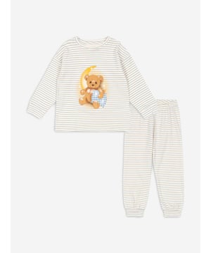 Konges Sløjd incorporate beautiful, eco-friendly technology into their charming aesthetics. This boys stripe blue pyjama set consists of a nightgown and a pair of night trousers in white with narrow, blue stripes. The nightgown has a golden print of a moon and a cute brown bear holding a cushion. The matching trousers come with an elastic edge at the waist to provide the utmost comfort. Nightgown Round Neckline, Long Sleeves, Wide Edges Trousers Wide Edges 100 Organic Cotton