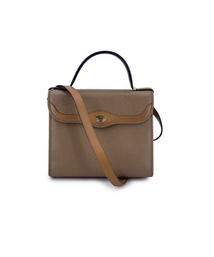 VINTAGE, RRP AS NEW
With its elegant trapeze silhouette and warm light brown leather, this vintage Christian Dior handbag is a true gem for collectors who adore the quiet sophistication of classic Dior. Designed to offer both structure and versatility, it's a timeless companion that balances form and function with ease.  This 2-way model features a top handle for ladylike carry and a removable shoulder strap, allowing it to be worn by hand, over the shoulder, or crossbody-perfect for adapting to any occasion. The front flap, secured with a button closure, is graced with an understated oval 'CD' tab, a subtle yet iconic nod to the house's legacy.  Inside, the bag is lined with care and fitted with a side zip pocket to keep your essentials neatly tucked away. The inner 'Christian Dior - Made in France' tag confirms its ity and proudly speaks to its origin in the heart of Parisian craftsmanship.  Chic, structured, and unmistakably Dior, this vintage piece is a timeless treasure for those who appreciate fashion with a story and the enduring elegance of French design. Condition Rating: B - VERY GOOD CONDITIONCondition Details: Gently used. Some normal wear of use (light scratches) on leather due to normal use. .Please check the photos carefully and ask if you need to know more details or if you have any doubts.Measurements (cm):Depth: 7.6Height: 20.3Length: 24.1Other Details: Dustbag? NoKeys? NoBox? No Measurments:  width: 76 mm length: 241 mm height: 203 mm strap length: 0 mm handle drop: 0 mm