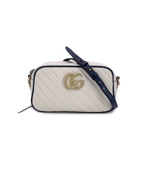 VINTAGE, RRP AS NEW
This beautiful Bag will come with a Certificate of ity provided by Entrupy. The certificate will be provided at no further cost.  Step into timeless elegance with this beautiful Gucci GG Marmont Small Zip Around Shoulder Bag, a true gem for lovers of vintage luxury. Crafted in soft white matelassé quilted leather, the bag is gracefully framed with navy blue leather trim-a nod to nautical chic that never goes out of style.  At the heart of its design, the iconic gold metal Torchon GG logo gleams proudly on the front, echoing Gucci's rich heritage. The bag zips open at the top to reveal a refined microfibre interior, complete with a convenient side pocket for your essentials.  The shoulder strap-an artful blend of adjustable navy leather and antique gold chain-lets you wear it crossbody or snug on the shoulder, adding versatility to its elegance. Inside, a discreet 'Gucci - Made in Italy' tag whispers top crftmanship, backed by a serial number hidden on its reverse.  A striking yet subtle piece, this GG Marmont model captures the spirit of classic Italian craftsmanship with a modern, collector-worthy twist.  Condition Rating: A - EXCELLENTCondition Details: Gently used. Minimal wear of use on leather trim. Minimal wear of use on the internal lining. Please check the photos carefully and ask if you need to know more details or if you have any doubts.Measurements (cm):Depth: 6.4Height: 12.7Length: 24.1Other Details: Dustbag? NoKeys? NoBox? No Measurments:  width: 64 mm length: 241 mm height: 127 mm strap length: 0 mm handle drop: 0 mm