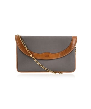 VINTAGE, RRP AS NEW
A timeless piece from the house of Dior, this vintage Christian Dior shoulder bag is a refined blend of Parisian elegance and understated luxury. Crafted in grey canvas with smooth beige leather trim, it carries the effortless charm of a bygone fashion era.  The front flap is adorned with an engraved CD logo, a subtle nod to Dior's legacy, and fastens with a magnetic button closure for both style and ease. Inside, a soft beige lining complements the exterior's muted tones, while a 'Christian Dior - Made in France' tag ates its heritage.  The gold-tone chain strap adds a touch of glam and versatility-wear it over the shoulder for a polished look, or tuck the strap inside and carry it as a chic clutch purse for evenings out.  Elegant, versatile, and collectible, this Dior piece is a must-have for vintage lovers and those who appreciate classic French craftsmanship.  Condition Rating: A - EXCELLENTCondition Details: Gently used. Please see the photos and/or ask if you need further information or if you have any doubts.Measurements (cm):Depth: 2.5Height: 17.8Length: 27.9Other Details: Dustbag? NoKeys? NoBox? No Measurments:  width: 25 mm length: 279 mm height: 178 mm strap length: 0 mm handle drop: 0 mm