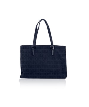 VINTAGE, RRP AS NEW
Step into the world of timeless Italian design with this beautiful Fendi tote bag, crafted in the iconic black Zucchino monogram canvas. A refined everyday companion, it features sleek black leather trim and matching handles that add structure and elegance to its silhouette.  The open top design reveals a thoughtfully organized interior, divided into two main compartments with a central zip section-ideal for keeping your essentials in order while on the go. The interior is lined in black canvas and stamped with the unmistakable 'Fendi - Made in Italy' tag, with the serial number embossed inside as a mark of ity.  Chic, understated, and unmistakably Fendi, this tote is a versatile piece of fashion heritage that blends practicality with effortless style. Condition Rating: B - VERY GOOD CONDITIONCondition Details: Gently used. Minimal fading on the upper borders. Please check the photos carefully and ask if you need to know more details or if you have any doubts.Measurements (cm):Depth: 7.6Height: 19.1Length: 25.4Other Details: Dustbag? NoKeys? NoBox? No Measurments:  width: 76 mm length: 254 mm height: 191 mm strap length: 0 mm handle drop: 0 mm