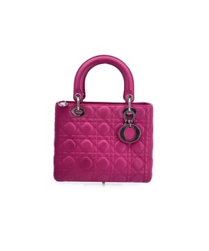 VINTAGE, RRP AS NEW
This beautiful Bag will come with a Certificate of ity provided by Entrupy. The certificate will be provided at no further cost.  A timeless icon and wearable piece of art, the Lady Dior bag captures the essence of Dior's Couture spirit with elegance and history stitched into every detail. This small-sized version is crafted by hand in fuchsia pink genuine leather, brought to life with the house's signature 'Cannage' topstitching-a pattern famously inspired by the Napoleon III chairs that graced Christian Dior's first fashion show in 1947.  Adorned with dangling DIOR letter charms in matching silver-tone hardware, the bag features double rigid leather handles, removable leather shoulder strap and a secure upper zipper closure. Inside, the grey fabric lining includes a side zip pocket, perfect for keeping essentials neatly tucked away. Finished with four protective metal feet, it balances practicality with poise.  A discreet 'Christian Dior Paris - Made in Italy' tag rests inside, a quiet nod to its impeccable craftsmanship. With a current retail price of €5,500, this Lady Dior is more than a handbag-it's a piece of fashion history made to be carried and cherished.  Condition Rating: A - EXCELLENTCondition Details: Gently used. Minimal wear of use on leather. Please check the photos carefully and ask if you need to know more details or if you have any doubts.Measurements (cm):Depth: 7.6Height: 19.1Length: 24.1Other Details: Dustbag? NoKeys? NoBox? No Measurments:  width: 76 mm length: 241 mm height: 191 mm strap length: 0 mm handle drop: 0 mm