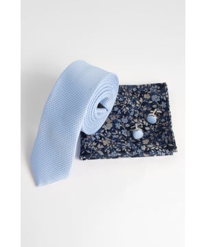 Textured tie with subtle micro-pattern for added visual interest
        Floral pocket square featuring navy base with contrasting pattern
        Matching round cufflinks with coordinated design
        Complete set presented in a sleek gift box
        Versatile accessory trio that works with various suit styles
    
    Add a touch of sophistication to your formal attire with this coordinated accessory set from Burton. The light blue textured tie offers a refined finish that pairs perfectly with the navy floral pocket square, creating a balanced look that shows attention to detail without appearing overdone. As seen on our model, this set complements a light grey suit brilliantly, though it would work equally well with navy or charcoal options. The matching cufflinks complete the ensemble, adding a polished touch to French cuff shirts. Perfect for weddings, important meetings, or those special occasions where you want to make an impression without appearing flashy. This versatile set allows you to customise your look while maintaining a cohesive style - ideal for the man who appreciates classic accessories with a contemporary twist. Machine washable for practical maintenance.