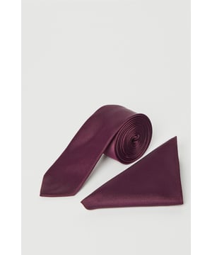 Classic tie and matching pocket square set for coordinated formal styling
        Sleek satin-like finish that catches the light beautifully
        Standard width tie with clean, straight edges for a timeless look
        Triangular pocket square designed for the classic peaked fold
        Burton-branded detailing on the reverse of the tie for authentic quality
    
    Add a touch of sophistication to your formal attire with this coordinated tie and pocket square set. The rich grape hue makes a refined statement when paired with a light grey suit as shown, creating a balanced contrast that works brilliantly for weddings, important meetings, or evening events. The tie features a clean-cut design that sits perfectly against a crisp white shirt, while the matching pocket square adds that essential finishing touch when arranged in your jacket pocket. Versatile enough for year-round wear, this set allows for effortless styling at business functions or special occasions. For smart casual events, try pairing with a textured blazer and open-collar shirt - the pocket square alone adds just the right amount of polish without appearing overdressed. Machine washable for convenient care, this Burton accessory set delivers classic British style that stands the test of time.
