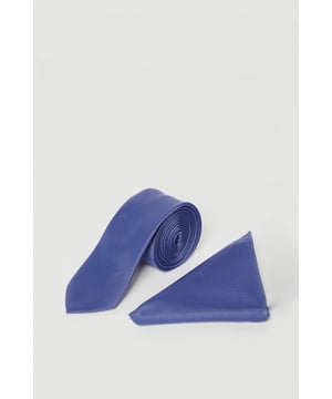 Sleek tie and matching pocket square set for coordinated formal styling
        Classic slim-width tie design perfect for modern suiting
        Smooth finish fabric with subtle sheen for sophisticated occasions
        Branded Burton label for authentic quality assurance
        Versatile one-size design suitable for standard collar shirts
    
    Complete your formal ensemble with this handsome steel blue tie and pocket square set from Burton. The perfectly matched duo offers effortless coordination for weddings, interviews, or important business meetings. The tie features a contemporary slim profile that pairs brilliantly with both tailored and regular fit suits, while the pocket square adds that essential finishing touch when folded into your jacket breast pocket. As shown, the set complements blue suiting magnificently, but works equally well with grey, navy or charcoal options. For a classic look, pair with a crisp white shirt and dark suit, or create a more relaxed smart-casual style with an Oxford button-down and blazer for those after-work drinks. Machine washable for convenient care, this versatile set will quickly become a cornerstone of your formal wardrobe.