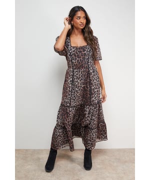 Elegant square neckline with charming scalloped edge detailing
        Romantic puff sleeves for a feminine silhouette
        Lightweight cotton voile fabric offering comfort and breathability
        Tiered midi-length skirt with graceful movement
        Flattering fitted bodice transitioning into a flowing skirt
    
    Make a statement in this captivating printed midi dress from Oasis. The square neckline framed with scalloped edging creates a distinctly feminine look, while the puff sleeves add a touch of romantic charm. The dress features a fitted bodice that gently flows into a tiered midi skirt, creating a silhouette that flatters various body types. Style with ankle boots and a leather jacket for an edgy daytime look, or pair with trainers and a denim jacket for casual weekend brunches. This versatile piece works beautifully for family gatherings or casual outings with friends. For cooler days, layer with a cropped cardigan and add a crossbody bag to complete your ensemble. The lightweight fabric ensures all-day comfort whilst maintaining that signature Oasis prettiness that's perfect for your everyday wardrobe.