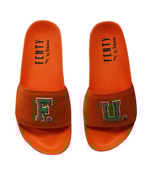 The Puma x Rihanna Fenty FU Women's Orange Sliders are a bold, fashion-forward collaboration that brings high-end style to casual footwear. Featuring a vibrant orange color, these sliders offer a striking and energetic look, perfect for making a statement. The sleek, modern design includes a wide strap with the signature Fenty branding, ensuring both comfort and style. The soft footbed provides a cushioned feel, while the durable rubber outsole offers reliable traction. Ideal for warm weather, beach days, or lounging by the pool, the Puma x Rihanna Fenty FU Sliders combine effortless comfort with high-fashion flair, making them a must-have for anyone looking to add a pop of color to their wardrobe.
Manufacturer Colour:

Scarlet Ibis/Bright Green