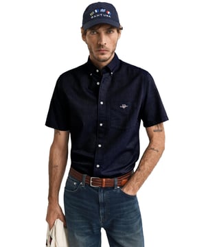 Timeless and versatile, the Classic Oxford Shirt is a smart-casual essential crafted from durable cotton. Designed in a regular fit with short sleeves, it’s perfect for the warmer months. Details include a button-down collar, curved hem, chest pocket with shield embroidery, and a box pleat with locker loop at the back for added comfort and style.