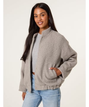 A cute and cosy shearling bomber jacket. The ultimate layering piece as we move into Spring/ Summer. Providing nothing but warmth and style. 