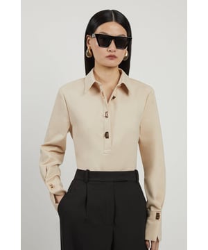 Embrace a smart aesthetic with this shirt, crafted from premium cotton with a classic collar, long sleeves, and golden claps for a premium finish. Pair with tailored trousers for a smart aesthetic. CollaredLong sleevesGolden claspsBrowse this seasons women's work tops or discover the full range of workwear now.Matching piece sold separately.