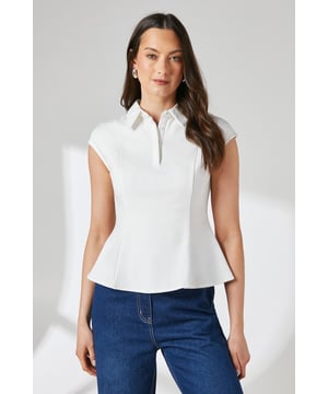 Elegant collared design with a sophisticated half-button placket
        Flattering peplum silhouette that creates a feminine waistline
        Crafted from stretchy ponte jersey fabric for all-day comfort
        Cap sleeve styling perfect for warmer weather
        Regular fit with a structured yet comfortable shape
    
    This versatile Principles peplum shirt combines classic styling with contemporary flair. The structured collar and half-button placket present a polished appearance, whilst the peplum detail adds a touch of femininity to your ensemble. Pair with wide-leg denim trousers and sandals as shown for a casual daytime look, or style with tailored trousers and ballet flats for family gatherings. The jersey fabric offers excellent stretch and recovery, ensuring comfort throughout the day without compromising on shape. This piece transitions effortlessly from office to weekend, making it an essential addition to your capsule wardrobe. The cap sleeve design provides a flattering silhouette that works beautifully with statement earrings to complete your look.