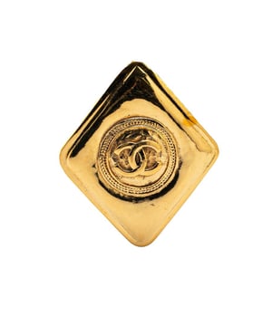 This brooch features a gold-tone metal body and a back pin closure.Brand: Chanel VintageCondition: PrelovedType: Costume BroochRating: B+Main Material: MetalDimensions (LxWxD): 5x4.2x0Comments: Exterior Back Scratched. Lock Scratched. Exterior Front Scratched.