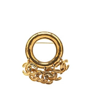 This brooch features a gold-tone metal body CC charms and a back pin closure.Brand: Chanel VintageCondition: PrelovedType: Costume BroochRating: B+Main Material: MetalDimensions (LxWxD): 6.5x8x0Comments: Exterior Back Scratched. Lock Rusty/Tarnished Scratched. Exterior Front Discolored Scratched.