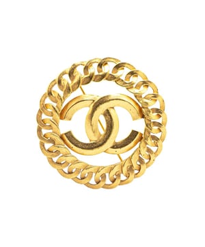 This brooch features a gold-tone metal body and a back pin closure.Brand: Chanel VintageCondition: PrelovedType: Costume BroochRating: ABMain Material: MetalDimensions (LxWxD): 5.5x5.5x0Comments: Exterior Back Discolored Scratched. Lock Scratched. Exterior Front Discolored Scratched.