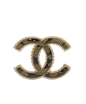 This brooch features a resin body and a back pin closure.Brand: Chanel VintageCondition: PrelovedType: Costume BroochRating: B+Main Material: PlasticDimensions (LxWxD): 3.7x5x0Comments: Exterior Back Scratched. Lock Scratched. Exterior Front Scratched.