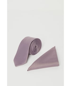 Sleek tie with matching pocket square for coordinated formal styling
        Classic slim-cut tie design with subtle texture for added dimension
        Triangular pocket square perfectly complements the tie for a polished look
        Burton-branded detailing showcases authentic craftsmanship
        Machine washable at 30 degrees for convenient care and maintenance
    
    Complete your formal ensemble with this sophisticated tie and pocket square set in a versatile dusty mauve hue. The slim-profile tie pairs seamlessly with the triangular pocket square, creating a refined look that works brilliantly with a variety of suit colours. As shown, the set complements a dark checked suit and crisp white shirt beautifully, offering a subtle touch of colour without overwhelming your outfit. Perfect for weddings, important meetings, or smart casual events at the local pub, this set allows you to express your personal style whilst maintaining a sharp appearance. The coordinated design takes the guesswork out of accessorising, making it an ideal choice for the gentleman who appreciates classic style with minimal fuss. Simply fold the pocket square to your preferred style - whether peaked, puffed or flat - to customise your look for any occasion.