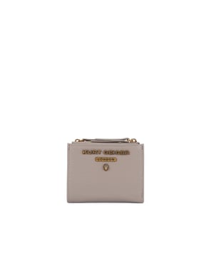 The Greenwich Mini Purse features a taupe grained leather exterior. There is an antiqued brass eagle head and branding on the front. 9cm (H), 11cm (L), 2cm (D).