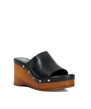 Resting on a wood-effect wedge, this stylish mule has been crafted from soft leather that moulds the foot. With silver stud detail around the top of the wedge, holding the leather upper in place, details like the embossed logo on the sole nod to our design heritage.