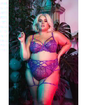 Introducing Walpole, these purple embroidered Brazilian tanga briefs epitomise grace and allure. Delicate embroidered flowers dance upon the intricate mesh, creating an enchanting visual feast. Designed to enhance your natural curves, its elasticated waist cinches and shapes with elegance. Embrace the comfort of the breathable mesh fabric while exuding confidence in the captivating hues of purple. Match with the Walpole Strappy Balconette Bra and Strappy Harness Suspender Belt. 

Purple Embroidered Tanga Brief
Elasticated Waist
Sheer mesh back
Gold hardware

Main: 55% Polyester 45% Polyamide. Main 2: 86% Polyamide 14% Elastane. Gusset Liner: 100% Cotton. Excluding Trims.