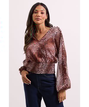 Elegant wrap detail neckline for a flattering silhouette
        Voluminous long sleeves with gentle gathering for a feminine touch
        Shirred elasticated hem creating a stylish cropped profile
        All-over animal print pattern adding contemporary flair
        Lightweight woven fabric offering comfortable wear throughout the day
    
    This Dorothy Perkins Animal Wrap Detail Shirred Hem Top combines sophistication with on-trend styling. The wrap neckline creates a flattering V-shape that frames your dcolletage beautifully without revealing too much, whilst the shirred elasticated hem defines your waist for a figure-enhancing effect. Style with your favourite high-waisted jeans and ankle boots for weekend brunches with the girls, or pair with tailored trousers and ballet flats for family gatherings. The versatile design transitions effortlessly from daytime casual to evening drinks, making it a wardrobe essential for the modern woman who values both style and comfort. Layer with a cardigan and add simple jewellery for a polished finish that works wonderfully for baby showers or informal office settings. This top offers the perfect balance of current fashion trends with timeless wearability.