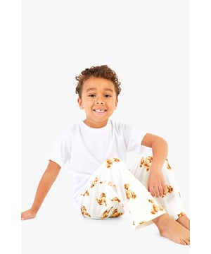 Adorable bear print pyjama bottoms
        Comfortable short-sleeved white top
        Matching set for the whole family
        Relaxed fit for ultimate comfort
        Perfect for festive celebrations
    
    Embrace the holiday spirit with this charming Kinder Br Familien Pyjama-Set from Boohoo. This delightful ensemble features a cosy white short-sleeved top paired with playful bottoms adorned with an enchanting bear print. The relaxed fit ensures maximum comfort for lounging at home or opening presents on Christmas morning. Ideal for creating cherished family moments, this set allows you to coordinate with your loved ones for a picture-perfect holiday look. Whether you're settling in for a festive film night or preparing for Santa's arrival, these pyjamas will keep you feeling snug and stylish. Add a pair of fluffy slippers and a warm dressing gown for those chilly winter evenings, and you're all set for a magical Christmas season.