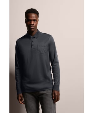 Erweitere deine Garderobe mit dem eleganten bugatti Langarm-Polo. Dieses Poloshirt besticht durch seine feine, zweifarbige Strukturoptik und die aufgesetzte Brusttasche mit Logostickerei. Aus einem Baumwoll-Mix gefertigt, bietet es Komfort und Stil zugleich. Der Polokragen und die 3-Knopf-Form verleihen eine klassische Note, während die körpernahe Passform Modern Fit eine schmeichelhafte Silhouette schafft.