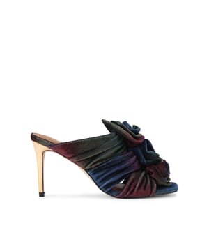 This Kurt Geiger Bloom Mule heel features a subtle ombre velvet with three flowers at the front of the straps. The heel is a stiletto style in mirrored gold. Heel height: 8cm.
