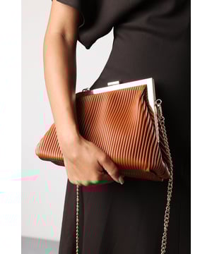 Elevate your evening look with the Haze Pleated Frame Clutch Bag, a timeless piece with a modern twist. Crafted from sleek pleated faux leather, this elegant design is complemented by a polished gold-tone frame and a matching chain strap for versatile styling. The structured silhouette keeps its shape while offering ample space for your night-out essentials. Perfect for weddings, parties, and special occasions. Key Features: • Material: Pleated-texture faux leather with smooth lining • Dimensions: 26cm (L) x 20cm (H) x 10cm (W) • Fastening: Gold-tone metal frame with clasp closure • Detail: Detachable gold chain strap for shoulder or crossbody wear