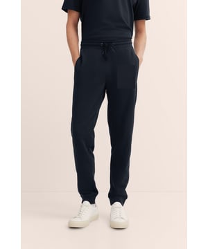 Fühl dich wohl in der bugatti Sweat-Trouser! Aus einem Baumwoll-Mix gefertigt, bietet diese lange Sweathose eine körpernahe Passform durch Modern Fit und höchsten Komfort. Die zwei seitlichen Eingrifftaschen und das bugatti Flaglabel an der hinteren Tasche verleihen ihr eine praktische und stilvolle Note. Die ideale Wahl für entspannte Tage!