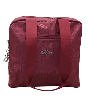 Bright, compact, and effortlessly versatile, the Kipling Ryana Basic Plus Red Grab Bag is your everyday go-to for organised style. With its bold red tone and signature lightweight design, this grab bag delivers both function and flair — perfect for workdays, weekends, and everywhere in between.
Key Features:
Durable Crinkle Nylon Fabric:

Lightweight, water-resistant, and easy to clean — ideal for daily use with long-lasting performance.

Spacious Main Compartment:

Features a zip-top closure with internal organisation including zip and slip pockets for storing your phone, keys, makeup, and more.

Dual Grab Handles + Detachable Shoulder Strap:

Offers multiple carry options — hold it by the handles for a smart look or wear it crossbody for hands-free ease.

Front and Back External Pockets:

Keep essentials easily accessible with extra zip pockets for on-the-go convenience.

Kipling Monkey Keyring Charm:

Iconic and playful — adds a touch of brand personality to the sleek silhouette.

Bold Red Colourway:

Eye-catching and energetic, making a confident statement while remaining easy to style.

Whether you're running errands, commuting, or travelling light, the Kipling Ryana Grab Bag delivers a polished, practical solution with a pop of vibrant personality.